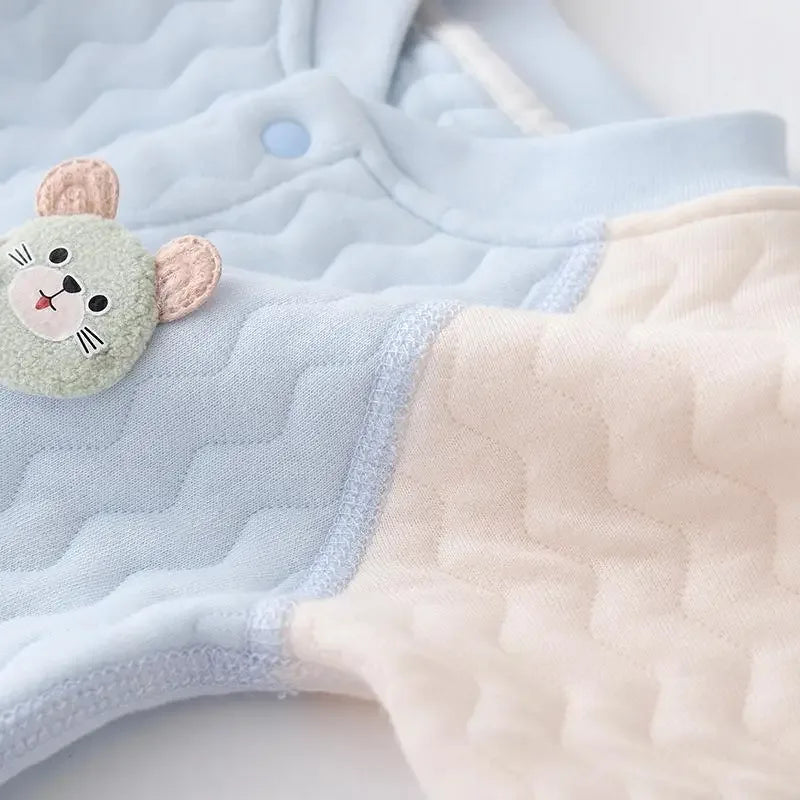 Light blue and beige cotton baby quilted romper with a cute mouse face patch