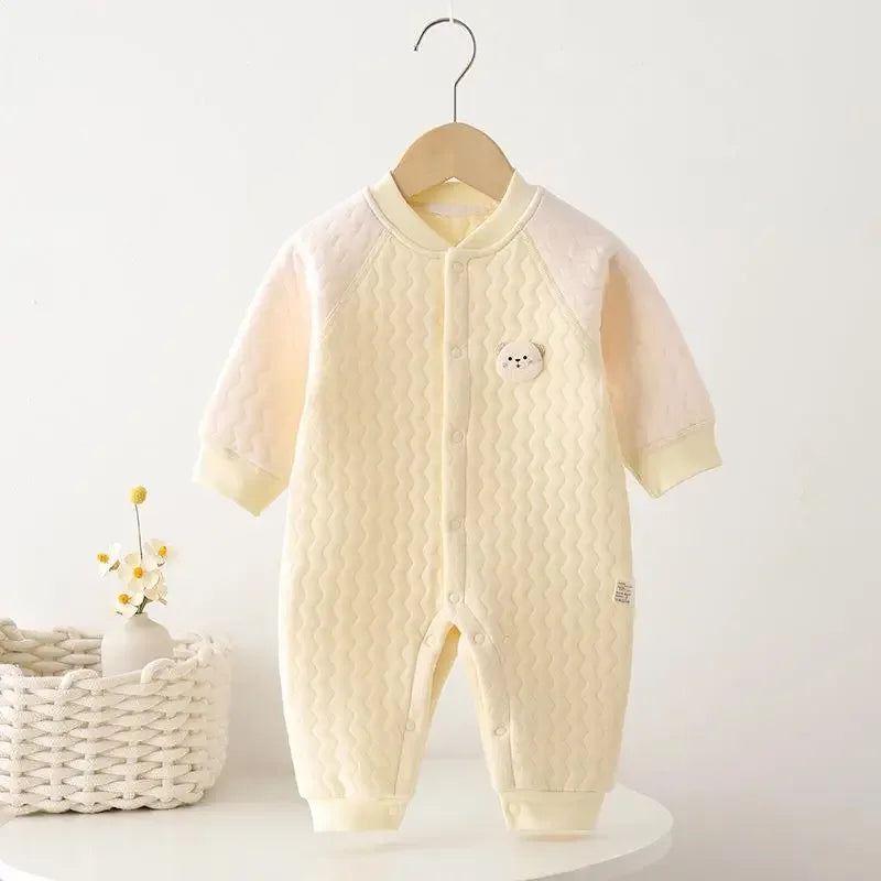 Cream yellow baby quilted romper made of soft cotton with long sleeves and bear patch detail