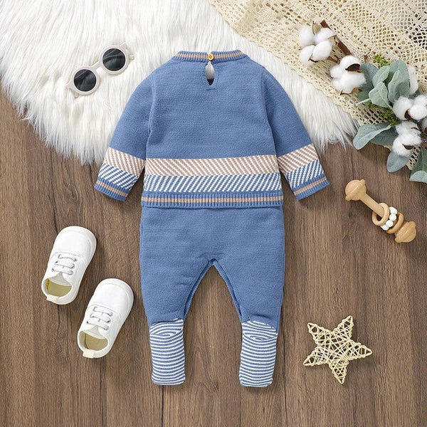 blue baby romper with striped cuffs and waistband for infants on wooden floor