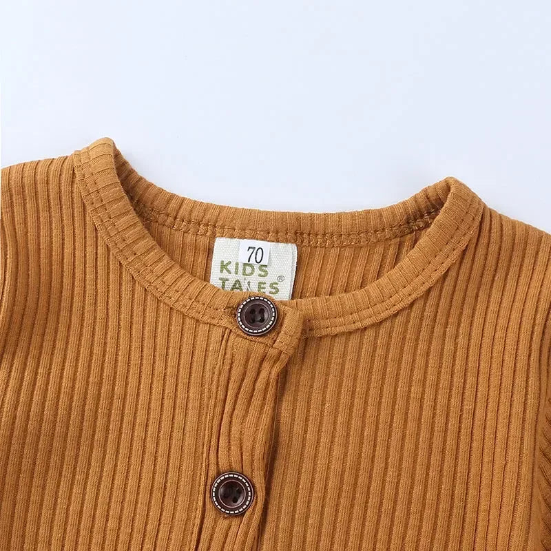brown ribbed baby romper for 3 to 6 months with round neckline and button detail