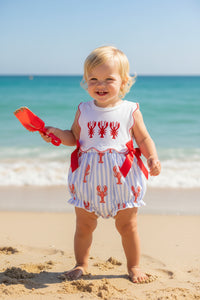 Baby romper with lobster pattern and red bows on a white background