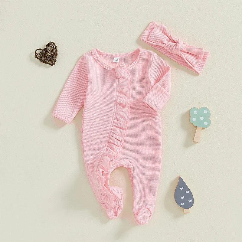 baby pink romper with ruffle detail, long sleeve and matching pink headband for infants