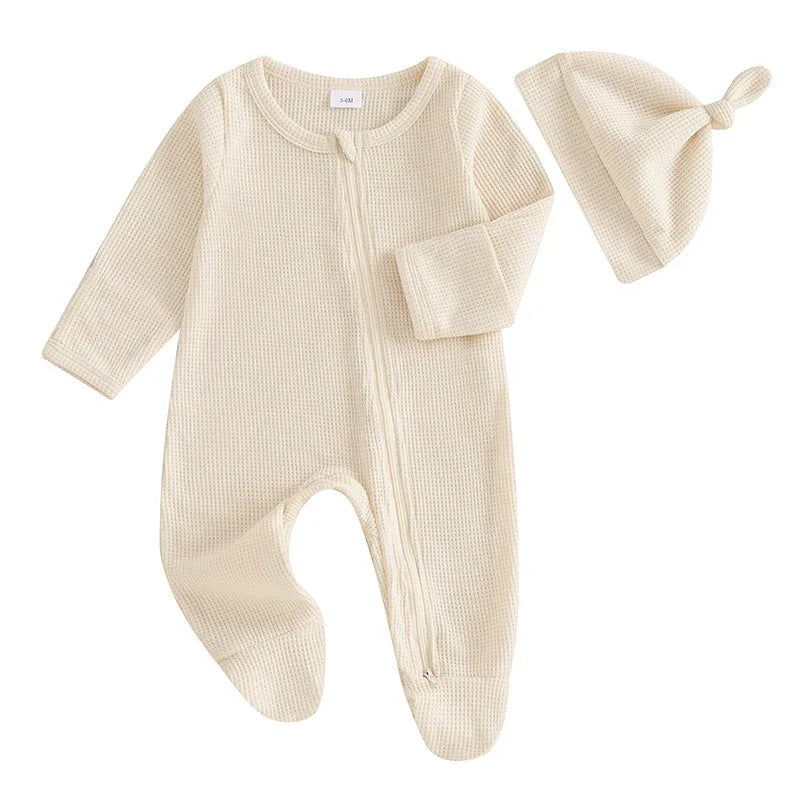 Cream baby romper set with hat in waffle knit fabric for newborns with long sleeves and footed legs