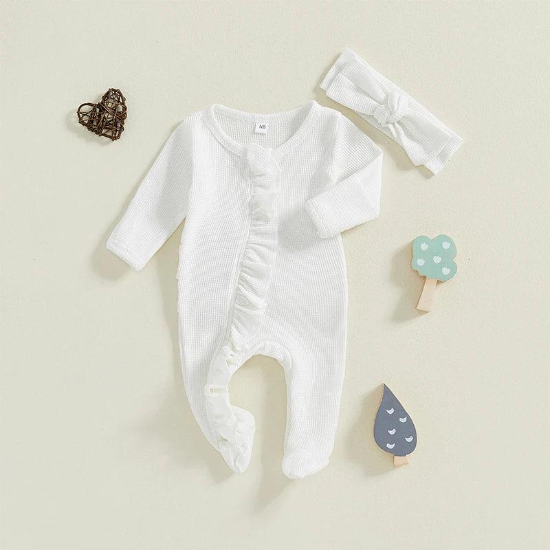 white baby romper with long sleeves and ruffle detail with matching white headband