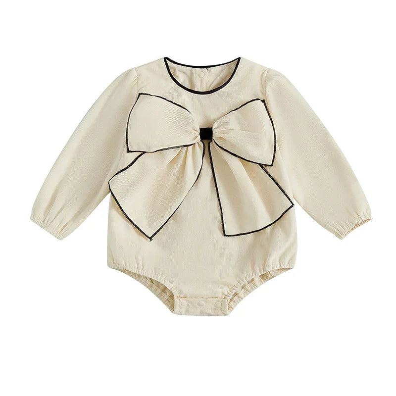 Cream baby romper with oversized bow and black trim, long sleeve for infants