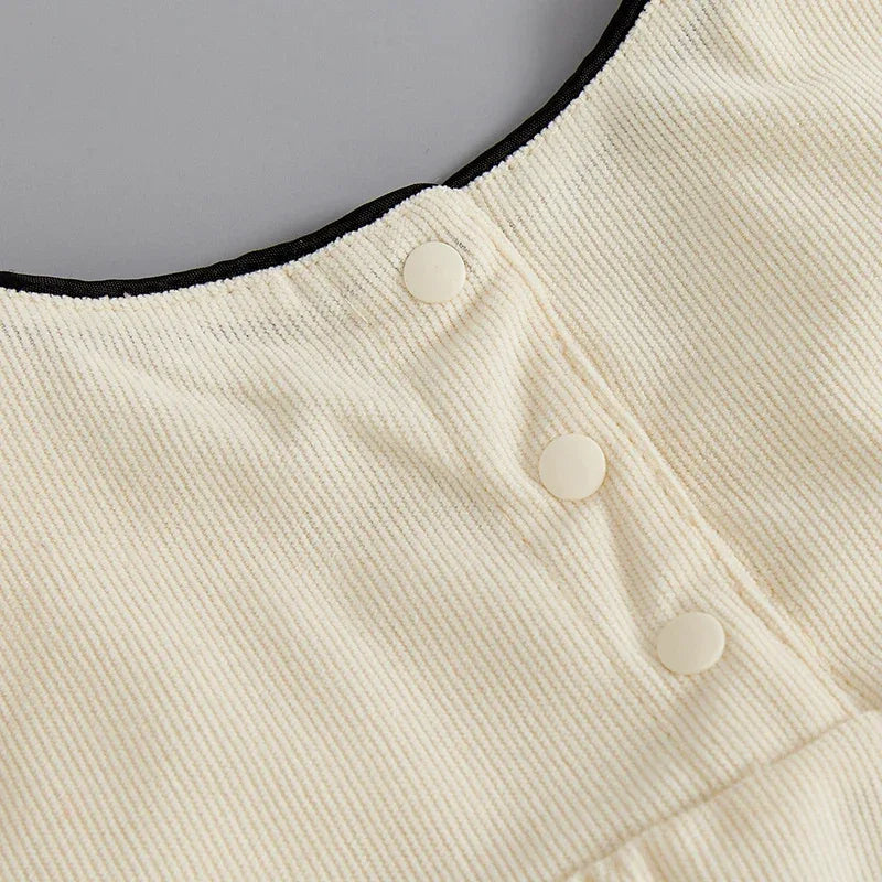 ivory baby romper with oversized bow in soft ribbed fabric with snap button closure for infants