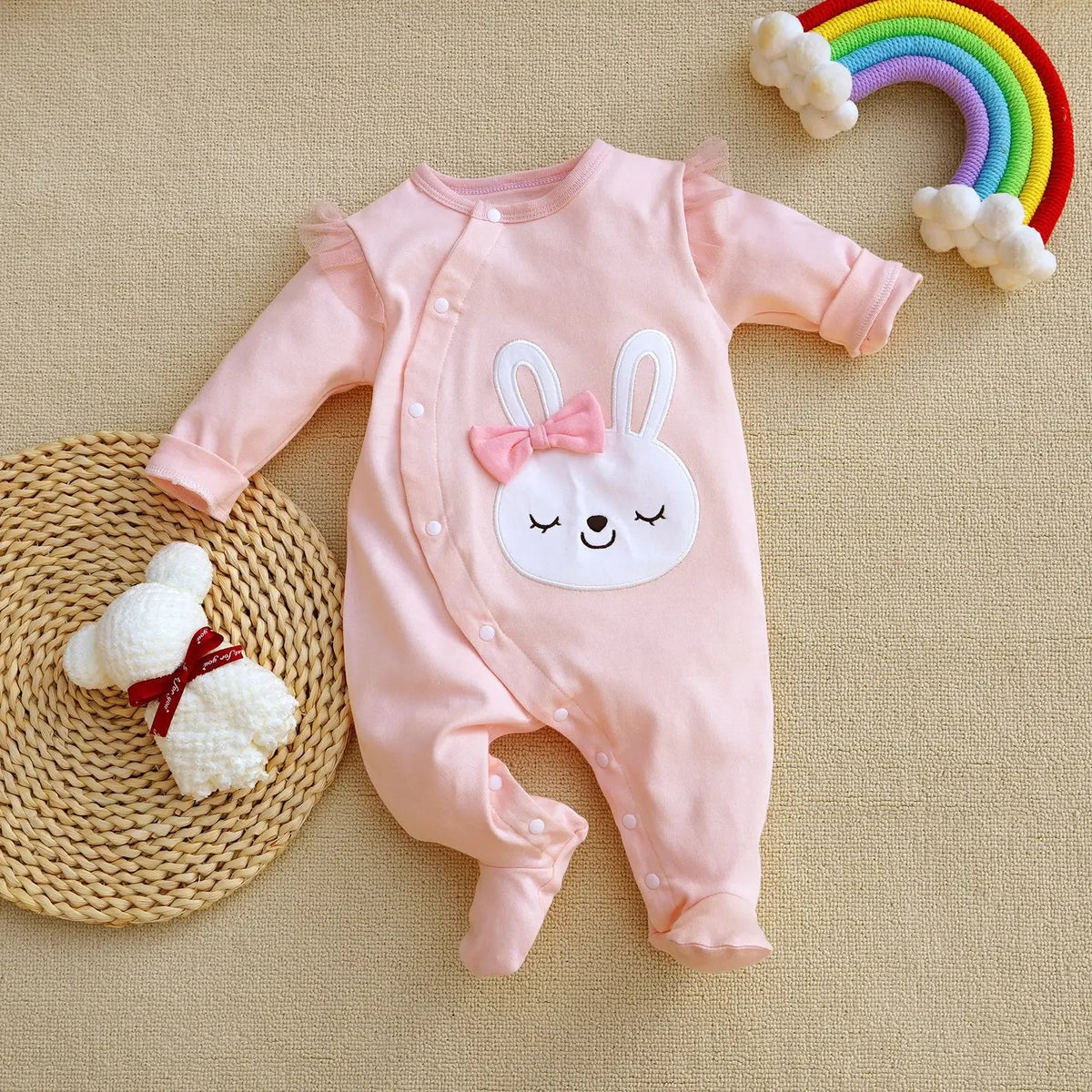 pink baby romper with long sleeves and bunny face design with bow for infants