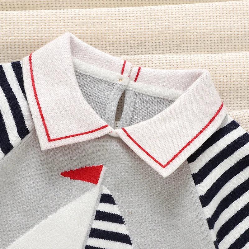 baby short sleeve romper with white collar and navy striped sleeves featuring a sailboat design