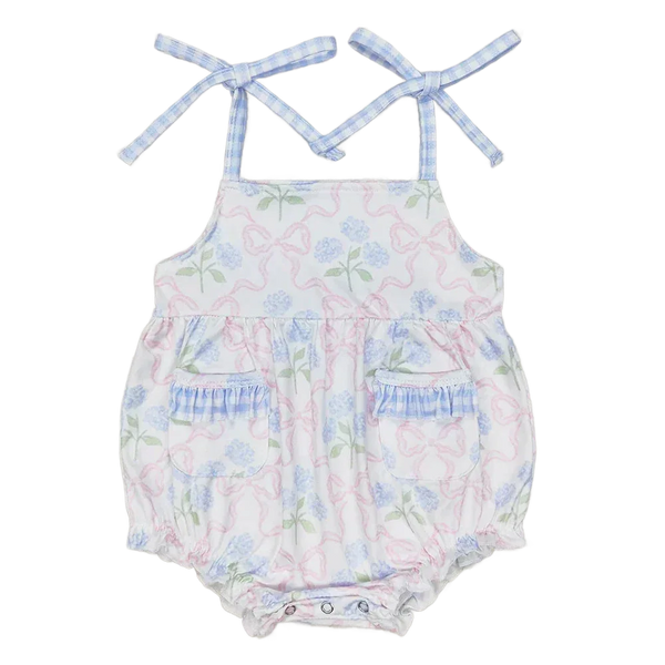 baby sunsuit with blue floral and pink bow print, adjustable tie straps, pockets, and ruffle details