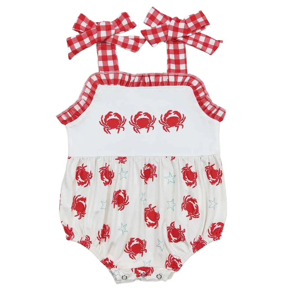 White and red baby sunsuit with red crab and star print, gingham straps and ruffle trim for infants
