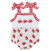 White and red baby sunsuit with red crab and star print, gingham straps and ruffle trim for infants