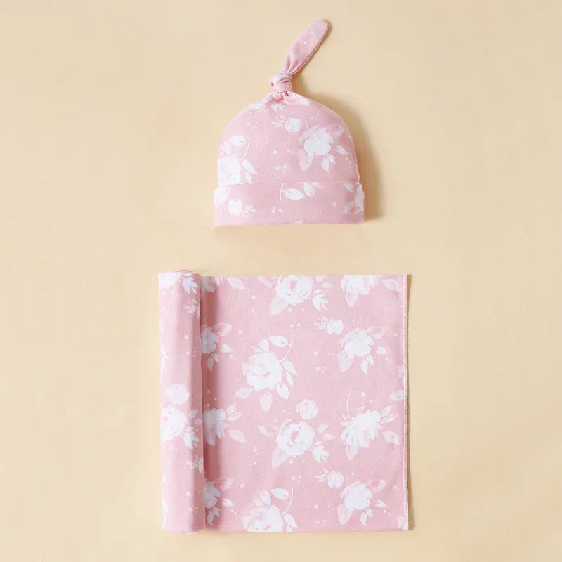 pink floral swaddle wrap and matching baby hat with knot detail for newborns