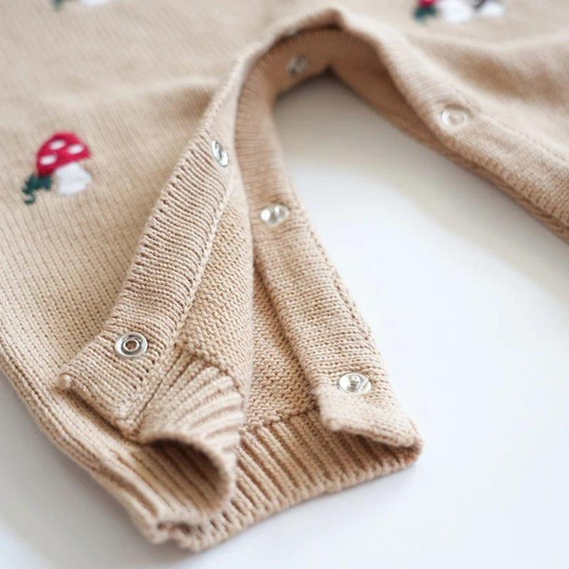 beige baby winter romper for newborns with mushroom embroidery and snap button closure