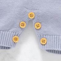 Light blue nautical baby romper for infants with wooden button details and ribbed cuffs