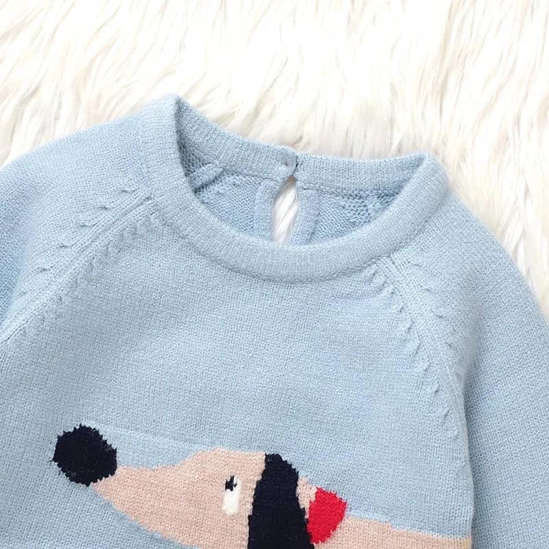 Light blue dachshund baby sweater romper for infants laid flat on white fur background