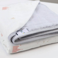 Gray and white bamboo muslin baby blanket with quilted texture and soft fabric