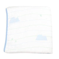 Folded white bamboo muslin baby blanket with blue trim and light mountain pattern for newborns