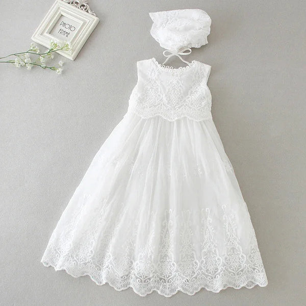 White sleeveless baptism dress for baby with lace detailing and matching bonnet