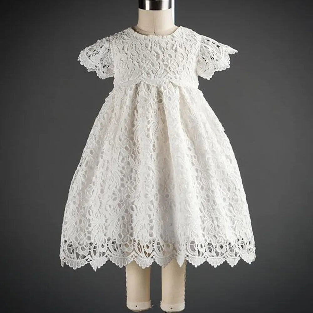 White lace baptism gown for babies with short sleeves and scalloped hem detail