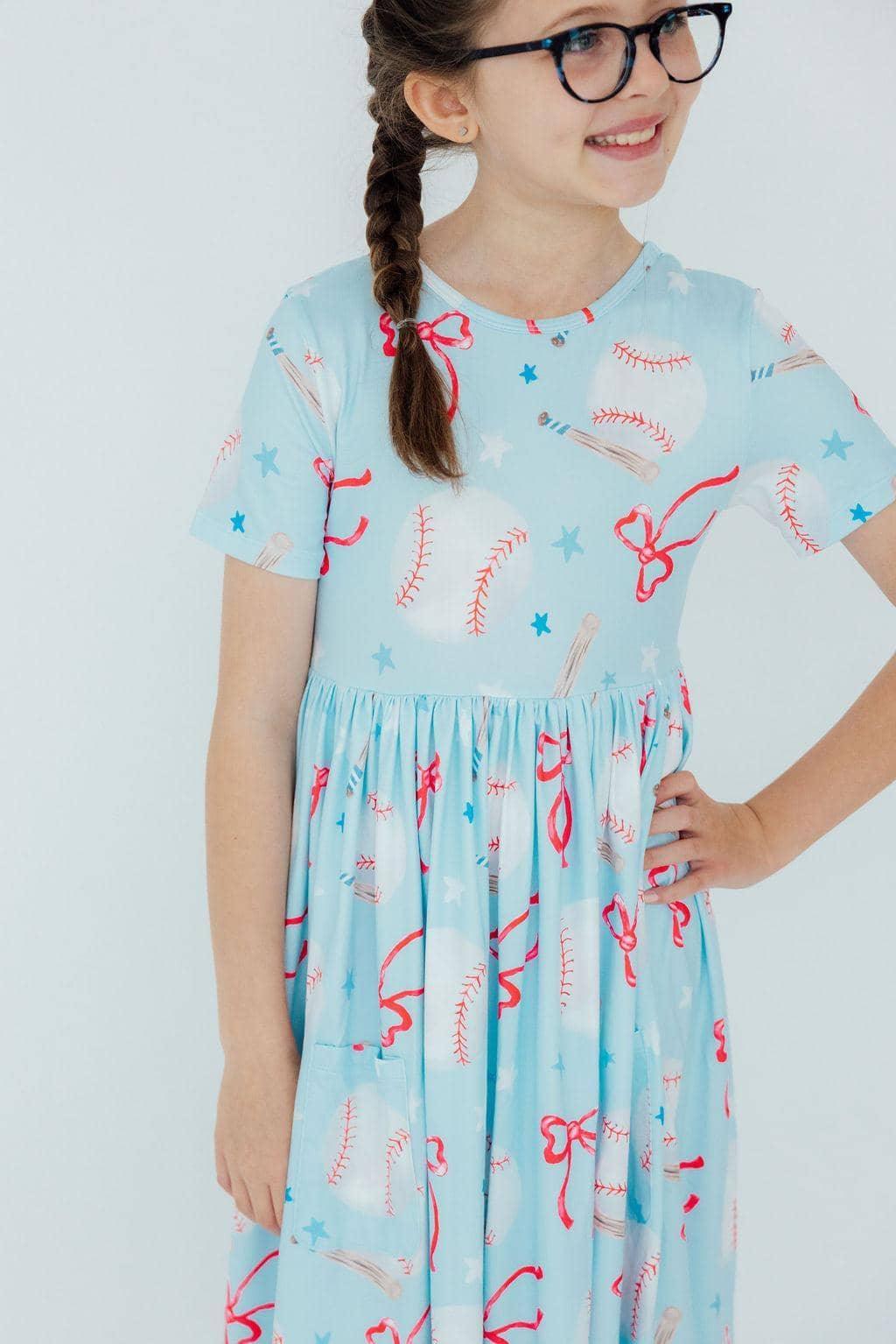 Girls light blue short sleeve baseball twirl dress for girls with playful baseball and bow print
