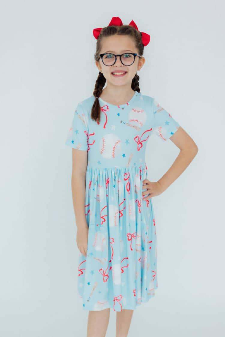 Girls light blue baseball twirl dress for girls with short sleeves and red and white baseball design
