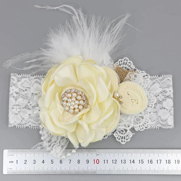 Cream and white beaded floral baby headband with lace, pearls, and feather details for newborns
