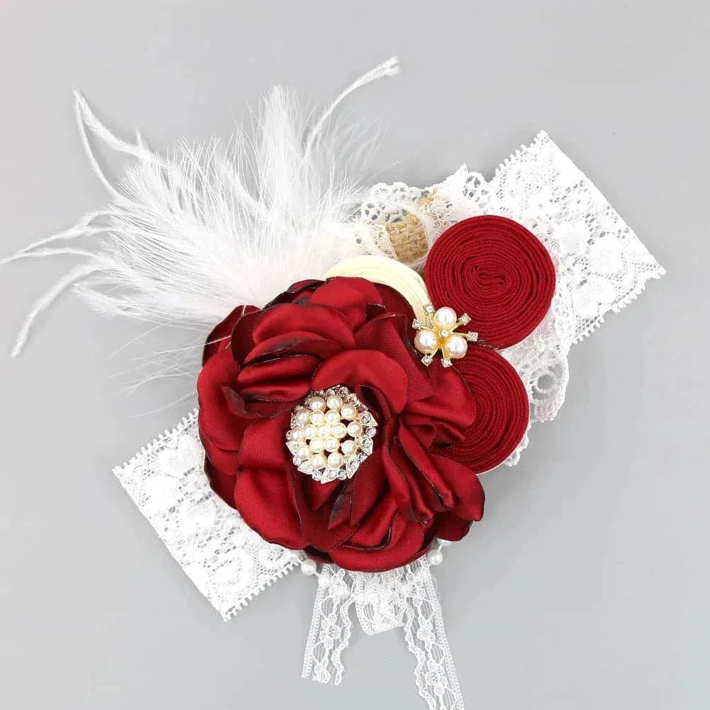 white lace beaded floral baby headband with large red fabric flower and feather detail for infants
