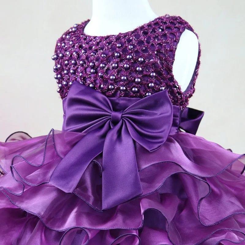 purple beaded special occasion dress for girls with satin bow and layered ruffle skirt