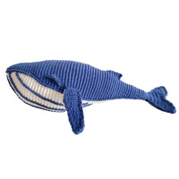 Hand-crocheted blue whale toy with pale belly and broad tail, made from soft organic cotton for imaginative play.