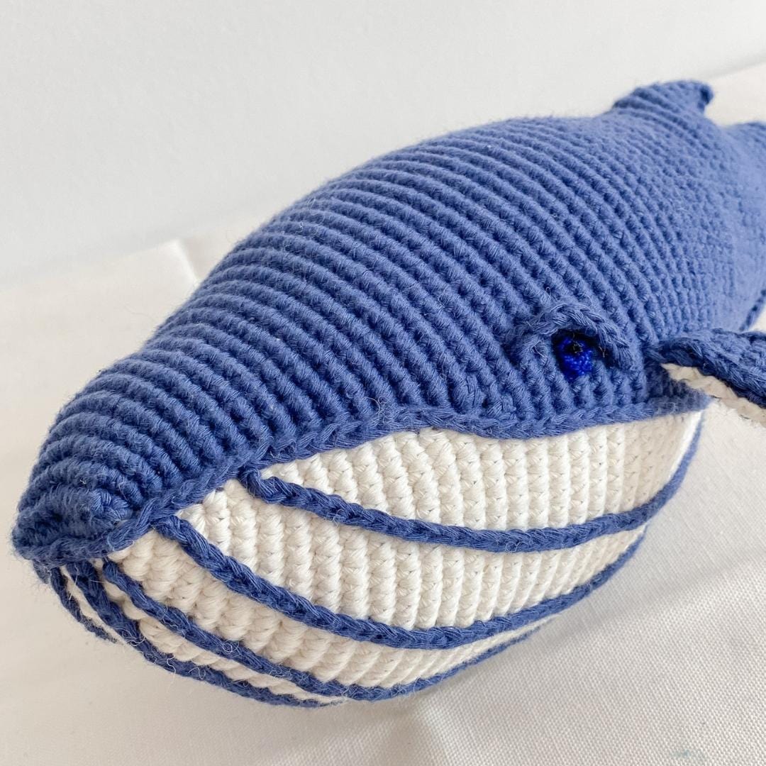 Hand-crocheted blue whale toy with a pale belly made from organic cotton. A soft sea animal for children.