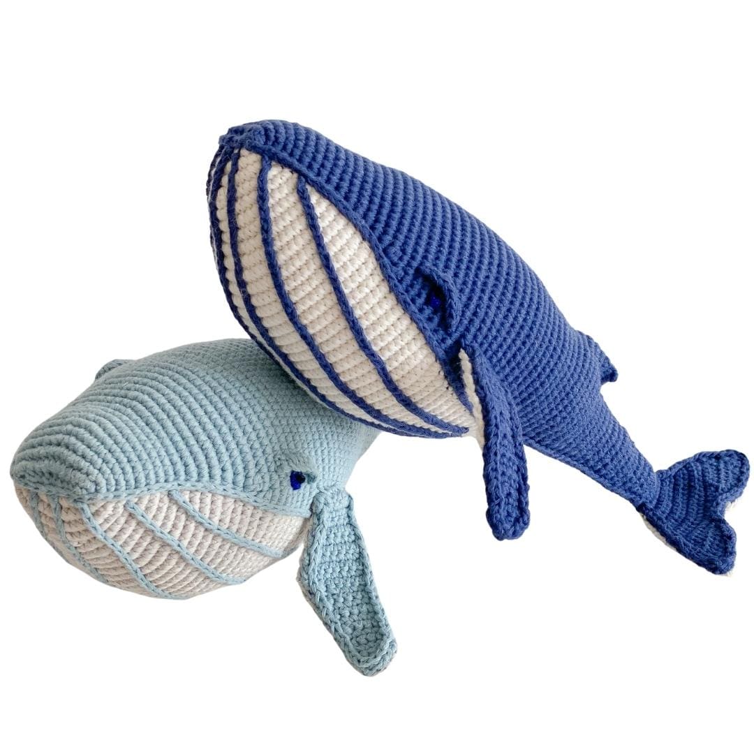 Hand-crocheted blue and light blue whale plushies with pale bellies, made from soft organic cotton for imaginative play.