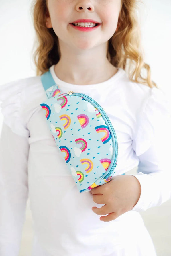 Girls light blue belt bag with colorful rainbow print and adjustable strap by Mila & Rose