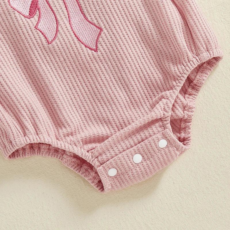 pink birthday romper for babies with waffle texture and snap buttons at the bottom