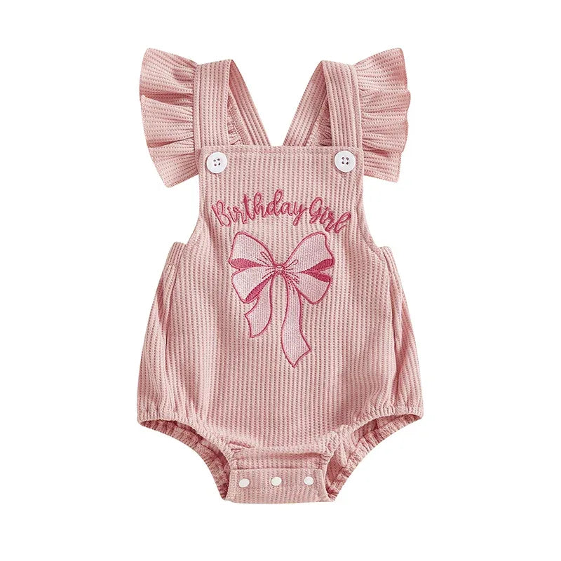Pink baby girl birthday romper with ruffle straps and embroidered bow design, newborn size