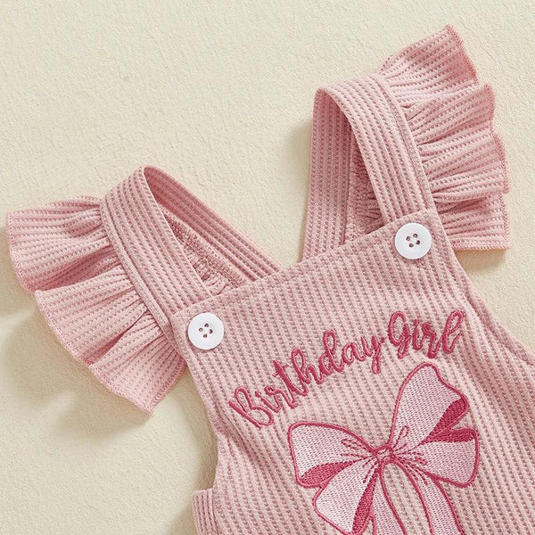 baby pink birthday romper with ruffle straps and embroidered birthday girl text for infants