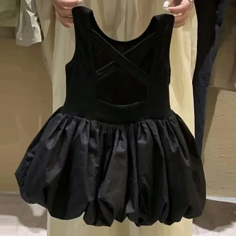 baby black girls party dress with cutouts held by person showing crisscross straps and bubble skirt