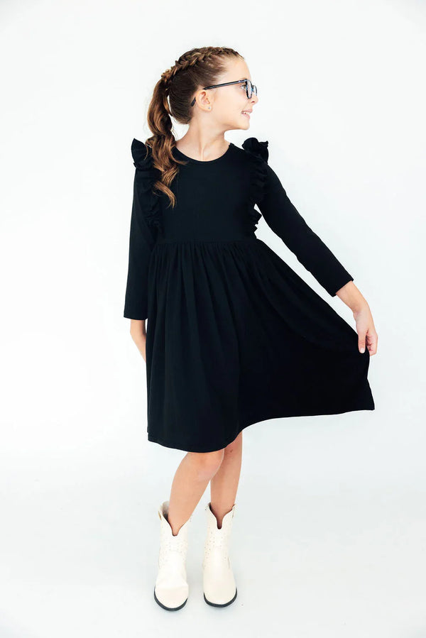 Girls black ruffle twirl dress for girls with long sleeves and ruffle shoulder details