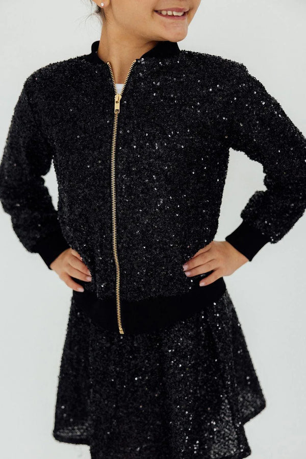 girls black sequin jacket with long sleeves and gold zipper closure