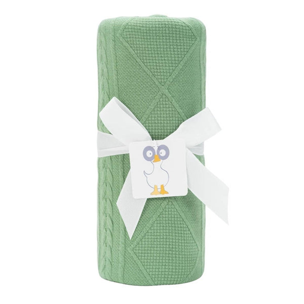 Green knit baby blanket for newborns rolled and tied with white ribbon from Goosewaddle