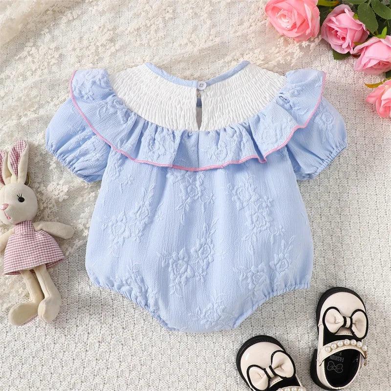 Blue embroidered baby bubble romper with white ruffled collar and pink trim for infants