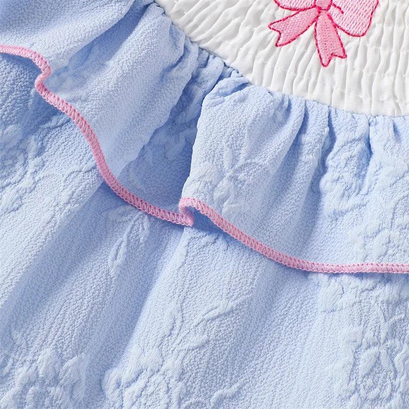 Blue embroidered baby bubble romper with pink trim and floral details for infants