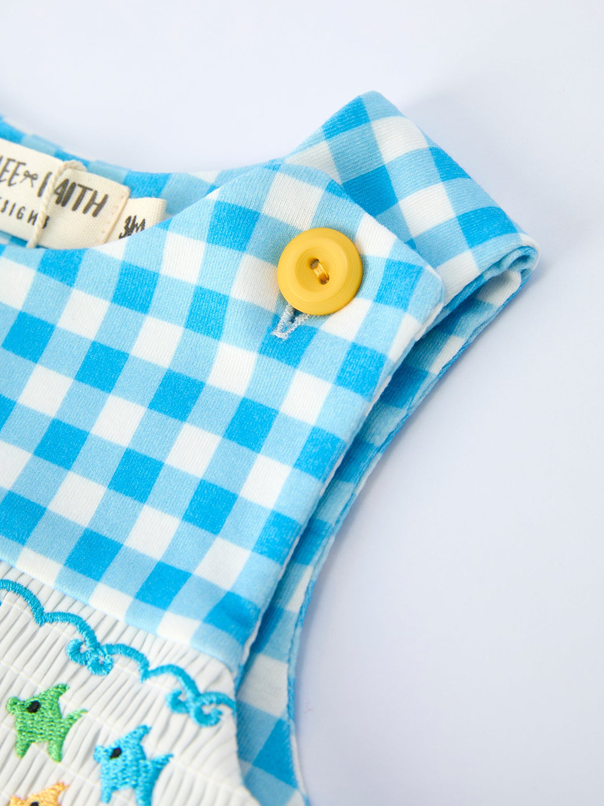 Rylee Faith Designs blue and white check fish embroidery baby romper for infants with yellow button detail
