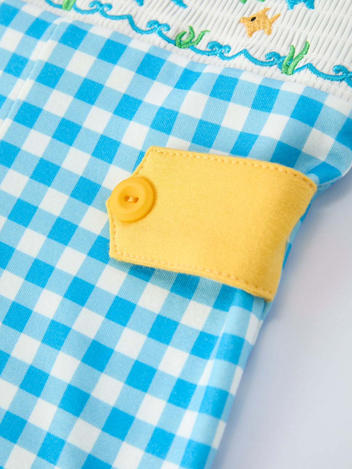 Rylee Faith Designs fish embroidery baby romper in blue check with yellow button detail for infants