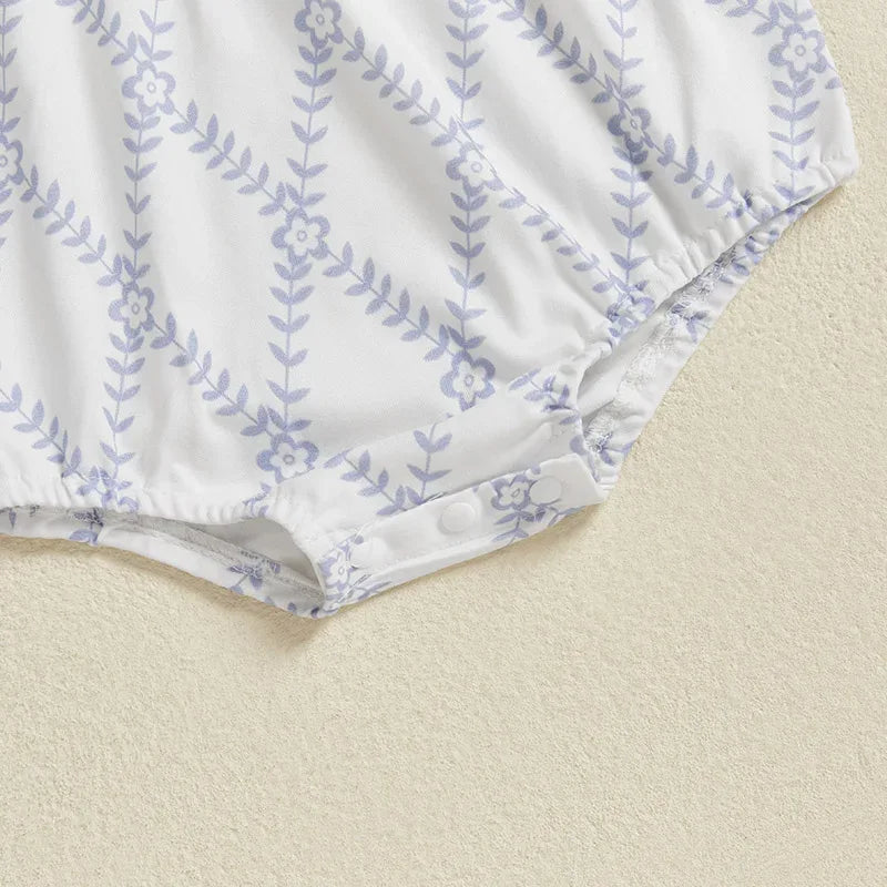 babies white and light blue romper with floral pattern and snap closures