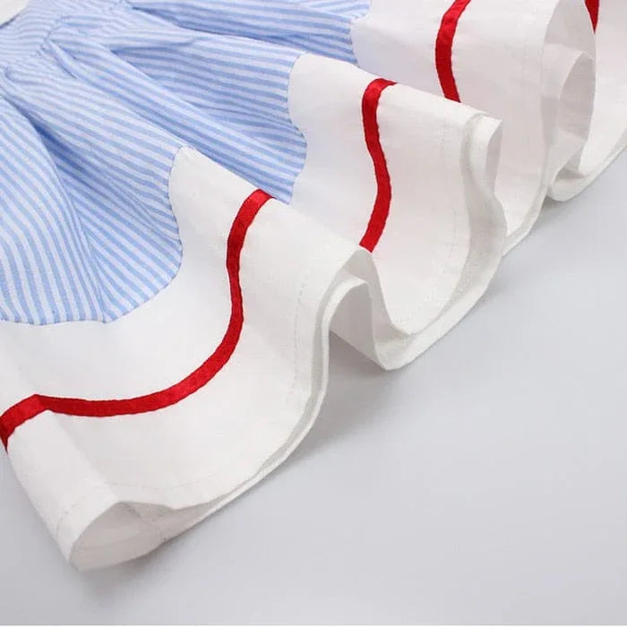 Girls blue and white striped dress with ruffled white hem and red trim detail for kids