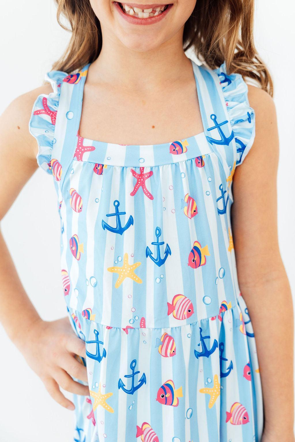 Girls light blue ruffle cross back dress with sea life print including anchors and fish dress ruffle