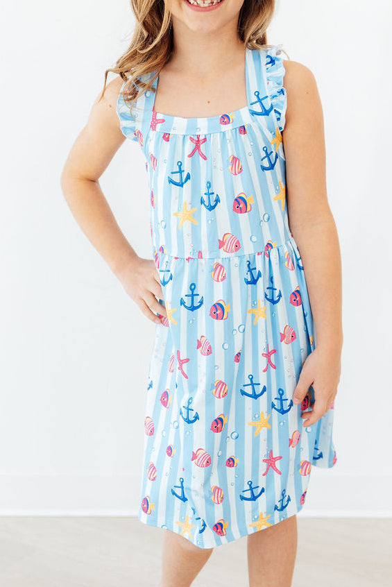 Girls light blue dress ruffle cross back with nautical print of anchors and seashells