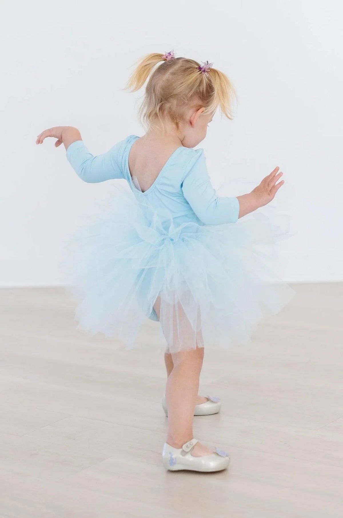 Toddler girl wearing blue tutu leotard for girls with 3/4 sleeves and fluffy skirt
