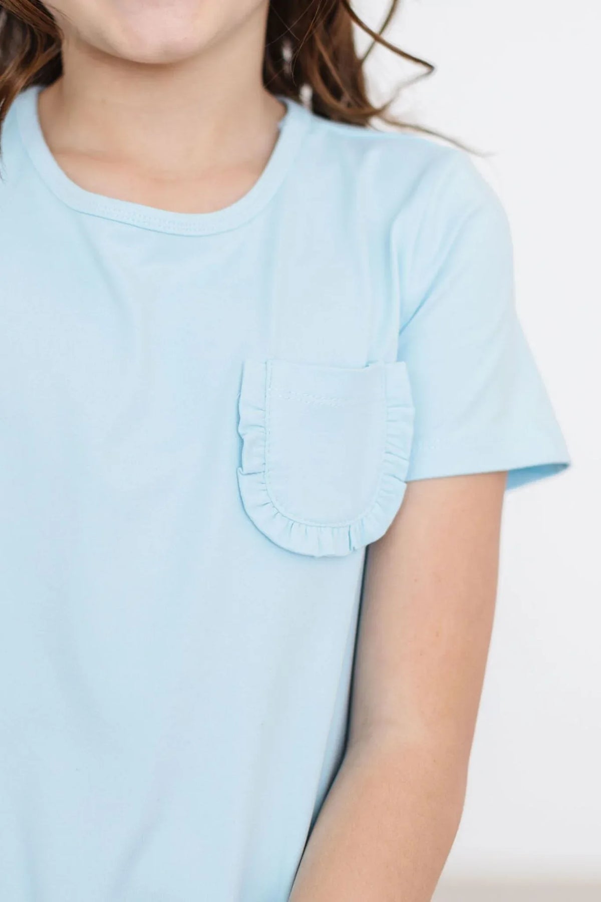 Mila & Rose bluebird t-shirt dress for girls in light blue with short sleeves and ruffled pocket detail