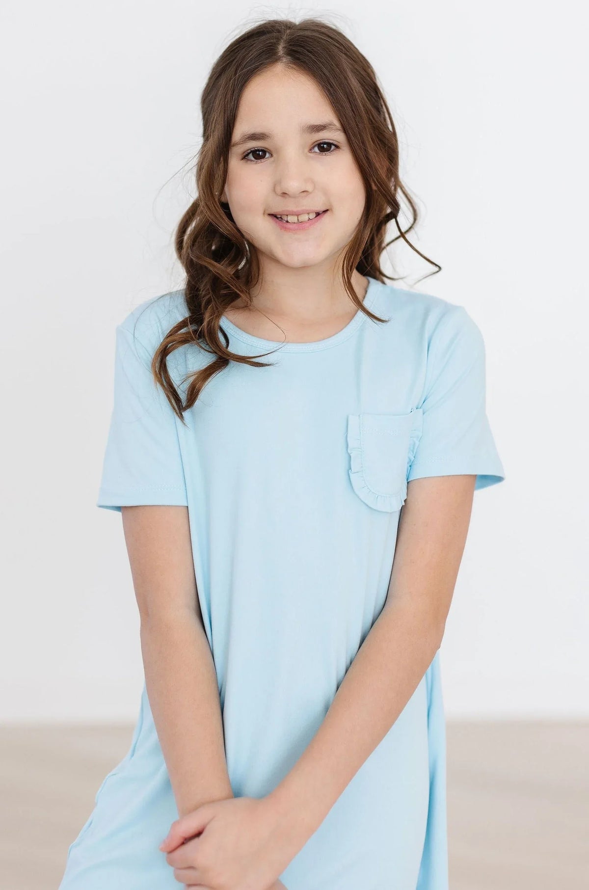 Girls light blue bluebird t-shirt dress for girls with short sleeves and pocket detail